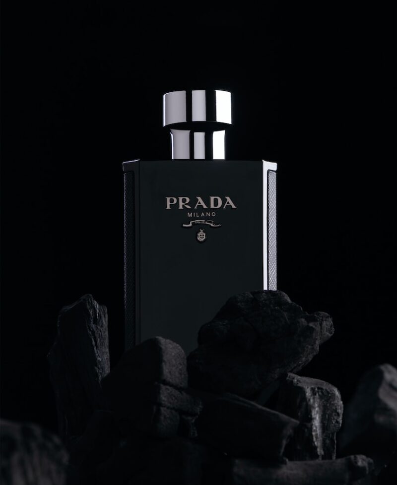 a black and white photo of a bottle of prada